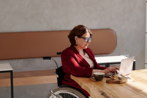 Woman in wheelchair using laptop computer